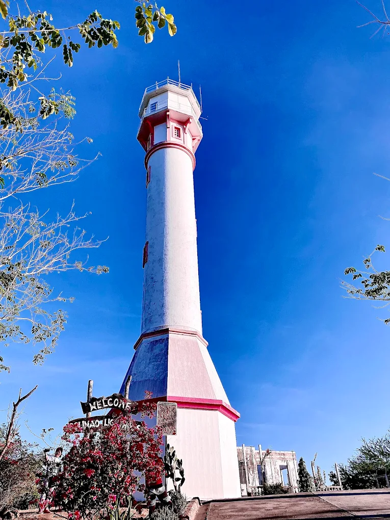 Cape Bolinao Lighthouse standing tall against a scenic coastal backdrop